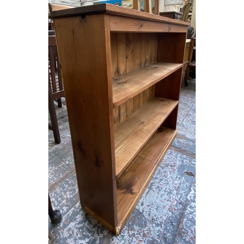 154 - A pine three tier bookcase - approx. 92cm high x 97cm wide x 23cm deep