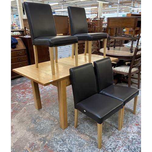 159 - A modern oak extending dining table and four black faux leather chairs - approx. 78cm high x 80cm wi... 