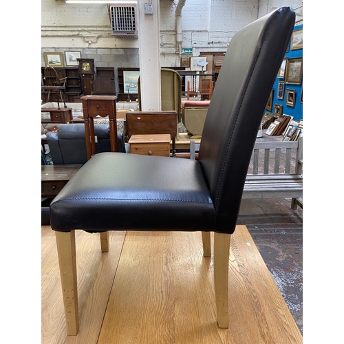 159 - A modern oak extending dining table and four black faux leather chairs - approx. 78cm high x 80cm wi... 