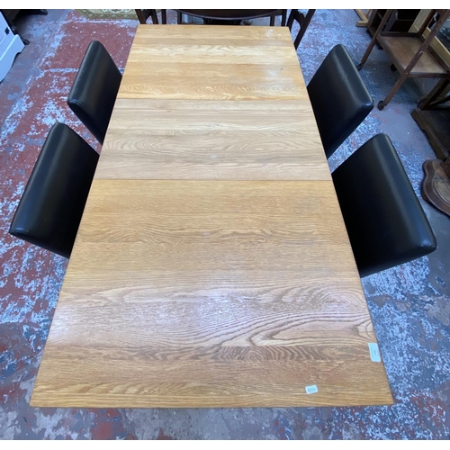 159 - A modern oak extending dining table and four black faux leather chairs - approx. 78cm high x 80cm wi... 