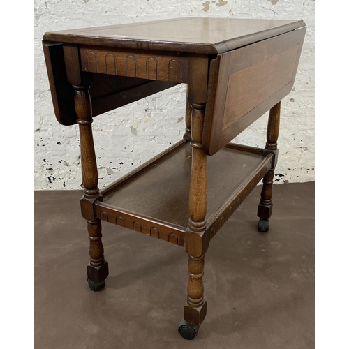 160 - A mid 20th century oak drop leaf two tier tea trolley