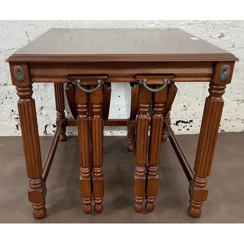 166 - A Regency style mahogany nest of tables on reeded supports - approx. 53cm high x 56cm wide x 56cm de... 