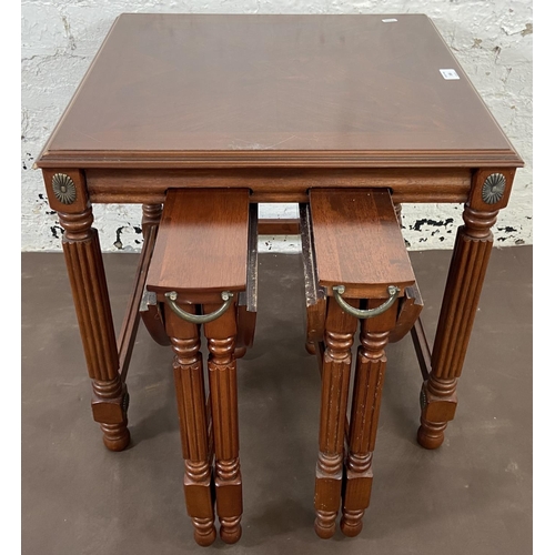 166 - A Regency style mahogany nest of tables on reeded supports - approx. 53cm high x 56cm wide x 56cm de... 