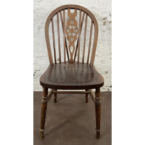 168 - Four beech wheelback dining chairs