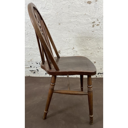 168 - Four beech wheelback dining chairs