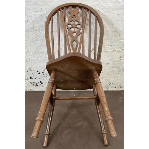 168 - Four beech wheelback dining chairs