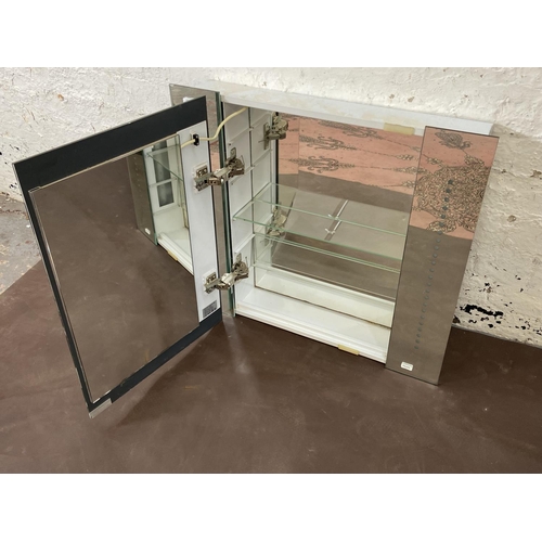 171 - A mirrored glass wall mountable LED bathroom cabinet - approx. 60cm high x 65cm wide x 12cm deep