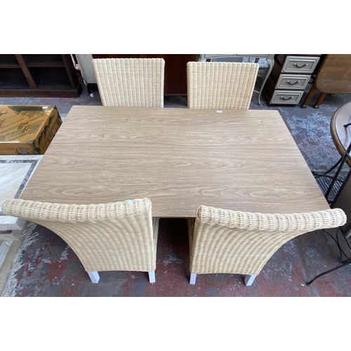 172 - A modern oak effect and grey painted rectangular dining table and four wicker chairs - approx. 76cm ... 