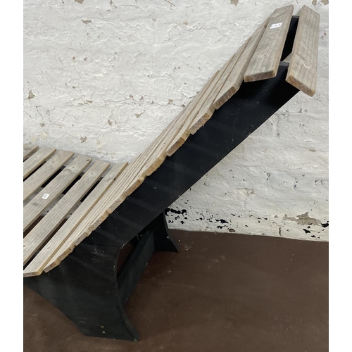 177 - A wooden slatted and black painted garden sun lounger - approx. 73cm high x 54cm wide x 156cm long