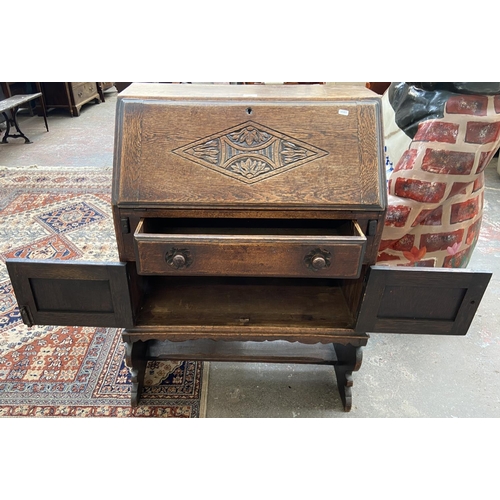 247 - A carved oak bureau - approx. 101cm high x 73cm wide x 43cm deep