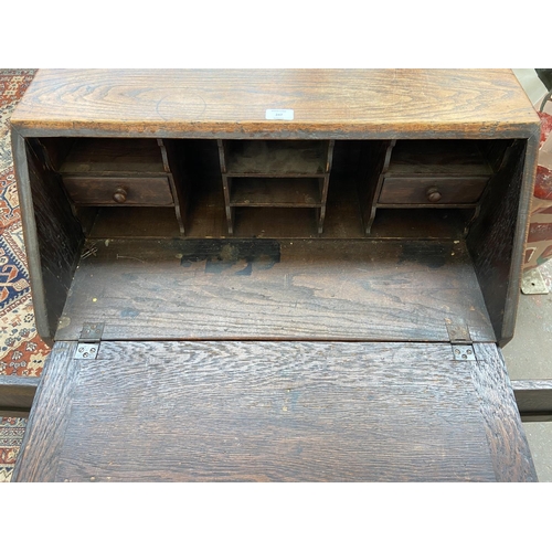 247 - A carved oak bureau - approx. 101cm high x 73cm wide x 43cm deep