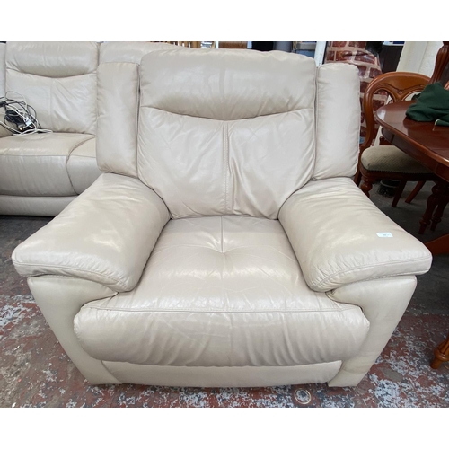 266 - A modern cream leather electric reclining three piece lounge suite comprising two seater sofa and tw... 