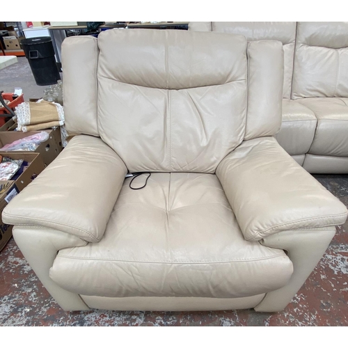 266 - A modern cream leather electric reclining three piece lounge suite comprising two seater sofa and tw... 