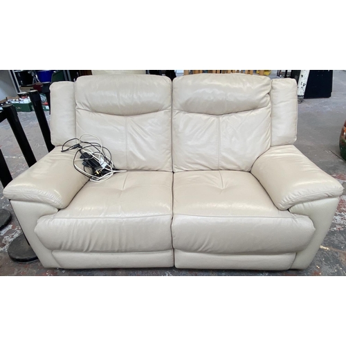 266 - A modern cream leather electric reclining three piece lounge suite comprising two seater sofa and tw... 