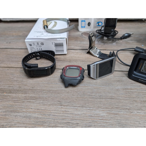 718 - A collection of boxed and unboxed fitness trackers