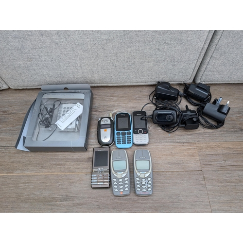 719 - Six mobile phones, four Nokia, one Motorola and one Sony Ericsson together with boxed M&S Travel FM ... 