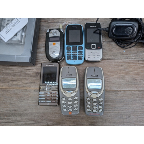 719 - Six mobile phones, four Nokia, one Motorola and one Sony Ericsson together with boxed M&S Travel FM ... 