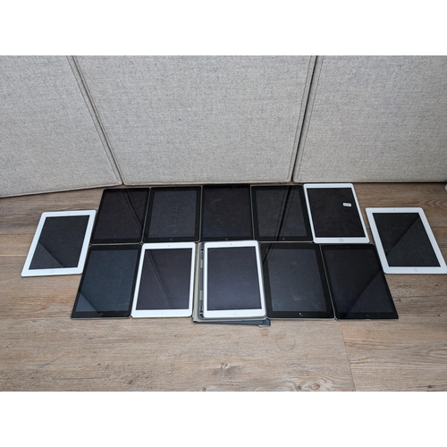 723 - A collection of Apple iPads to include A2197, A1395, A1474, A2602, A1458 etc.