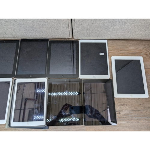 723 - A collection of Apple iPads to include A2197, A1395, A1474, A2602, A1458 etc.