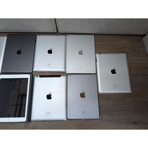 723 - A collection of Apple iPads to include A2197, A1395, A1474, A2602, A1458 etc.