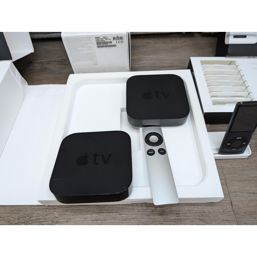 727 - A collection of Apple items to include three Apple TV streaming devices, iPod Nano 4th generation, b... 