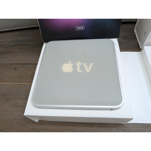 727 - A collection of Apple items to include three Apple TV streaming devices, iPod Nano 4th generation, b... 