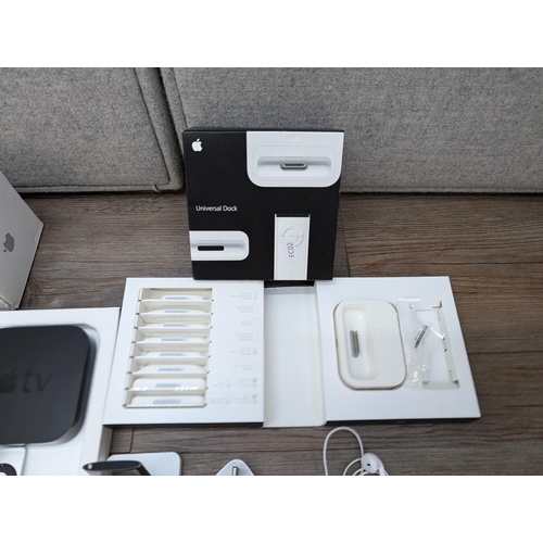 727 - A collection of Apple items to include three Apple TV streaming devices, iPod Nano 4th generation, b... 