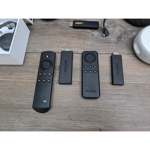 732 - A collection of home electronics to include two Amazon Fire sticks, boxed Google Chromecast, two Ama... 