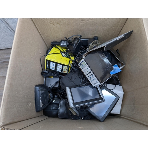 736 - A collection of boxed and unboxed satnavs to include Garmin, TomTom, NavMan etc.