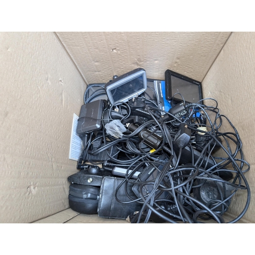 736 - A collection of boxed and unboxed satnavs to include Garmin, TomTom, NavMan etc.