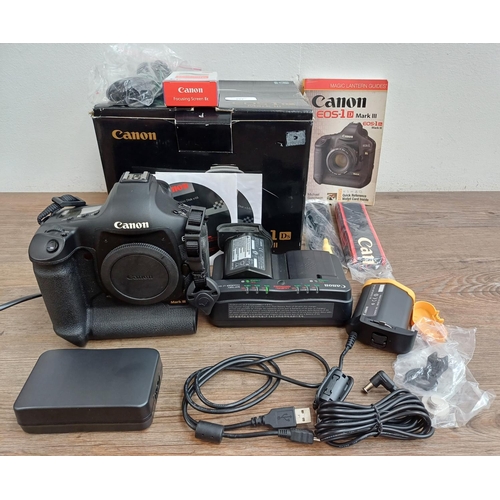 593 - A boxed Canon EOS-1Ds Mark III 21mp professional full-frame DSLR camera body with power adapter, str... 