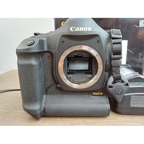 593 - A boxed Canon EOS-1Ds Mark III 21mp professional full-frame DSLR camera body with power adapter, str... 