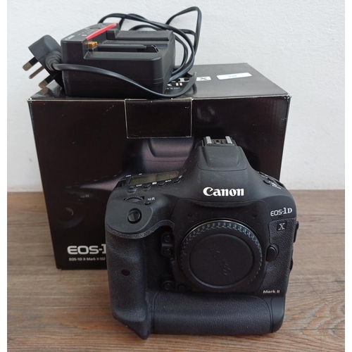 594 - A boxed Canon EOS-1D X Mark II 20.2mp professional full-frame DSLR camera body with battery and char... 