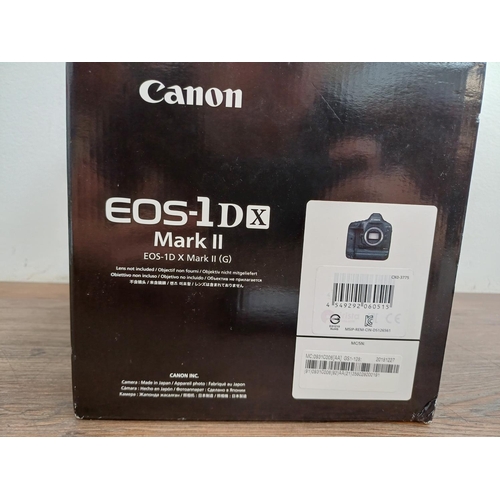 594 - A boxed Canon EOS-1D X Mark II 20.2mp professional full-frame DSLR camera body with battery and char... 