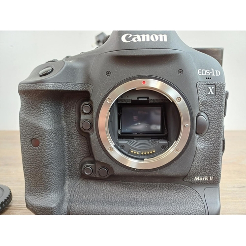 594 - A boxed Canon EOS-1D X Mark II 20.2mp professional full-frame DSLR camera body with battery and char... 