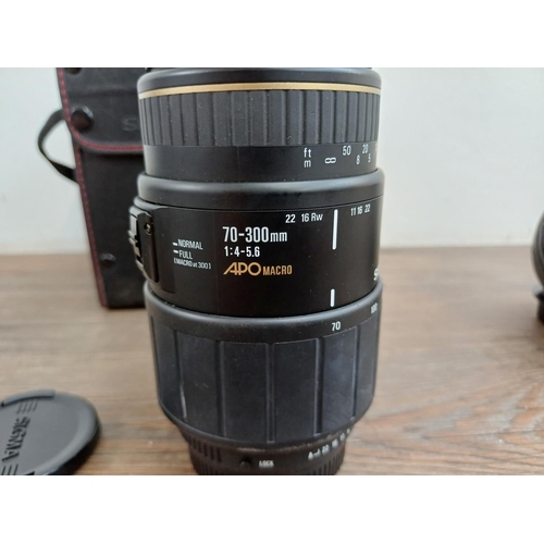 596 - Five Sigma camera lenses to include cased 70-300mm 1:4-5.6 APO macro, Sigma 75-300mm 1:4.5-5.6AF-APO... 