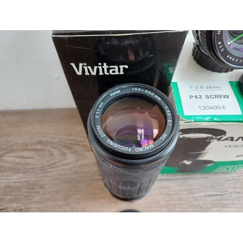 597 - Five boxed camera lenses, one Vivitar MC 1:5.6-6.7 100-300mm macro focusing zoom, one Nikon Nikkor A... 