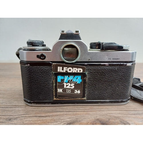 603 - A Nikon FE 35mm SLR camera fitted with Nikkor 28-85mm 1:3.5-4.5 lens