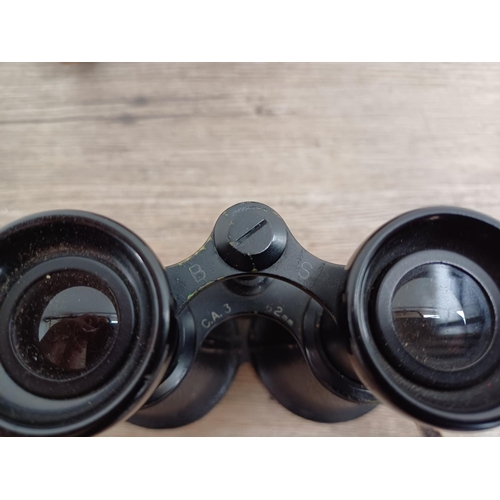 606 - A cased pair of vintage binoculars marked B S C.A.3 62mm