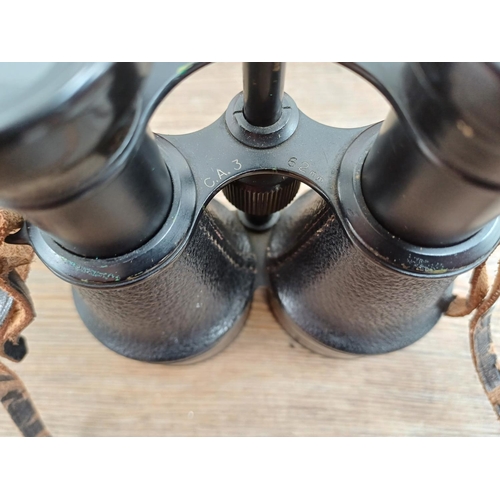 606 - A cased pair of vintage binoculars marked B S C.A.3 62mm