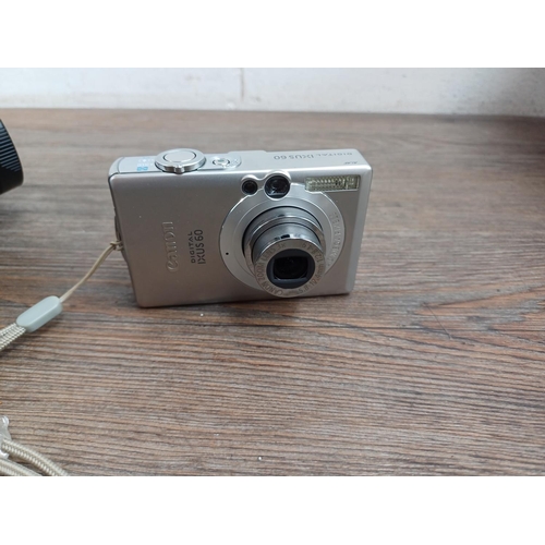 607 - Four compact digital cameras with accessories, one boxed Canon IXUS 105 12.1mp with software discs, ... 