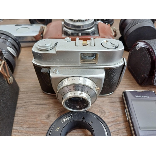 609 - A collection of lenses and cameras to include Minolta 7000 Maxxum 35mm SLR, Ihagee Exa II body, Niko... 