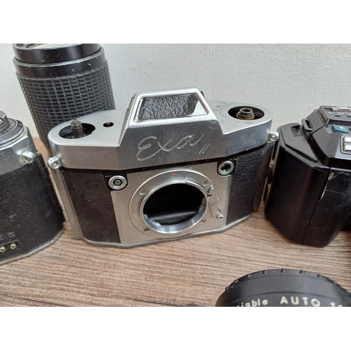 609 - A collection of lenses and cameras to include Minolta 7000 Maxxum 35mm SLR, Ihagee Exa II body, Niko... 