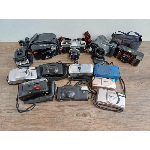 614 - A collection of Olympus cameras to include cased XA 35mm rangefinder, OM20 35mm SLR fitted with Zuik... 