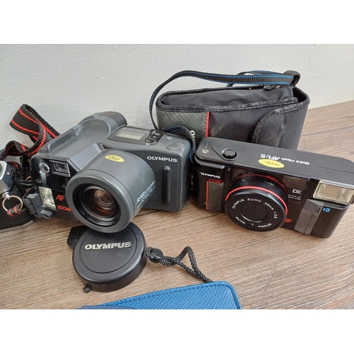 614 - A collection of Olympus cameras to include cased XA 35mm rangefinder, OM20 35mm SLR fitted with Zuik... 