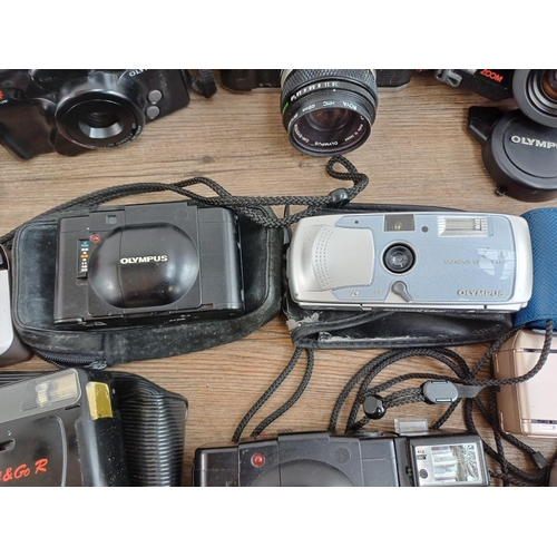 614 - A collection of Olympus cameras to include cased XA 35mm rangefinder, OM20 35mm SLR fitted with Zuik... 