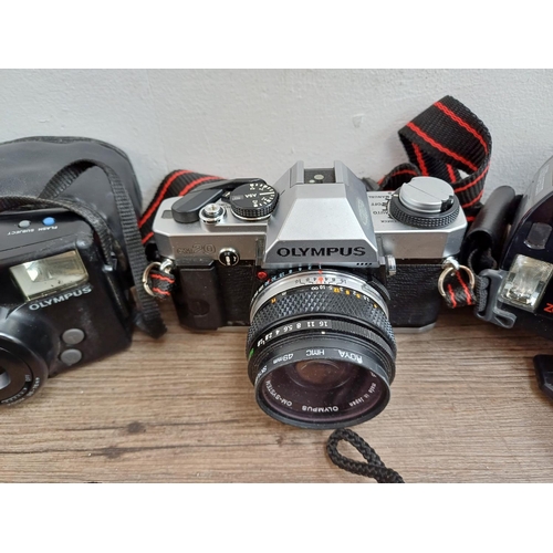 614 - A collection of Olympus cameras to include cased XA 35mm rangefinder, OM20 35mm SLR fitted with Zuik... 