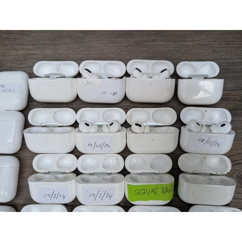 683 - A collection of Apple AirPod and AirPod style charging cases some with contents