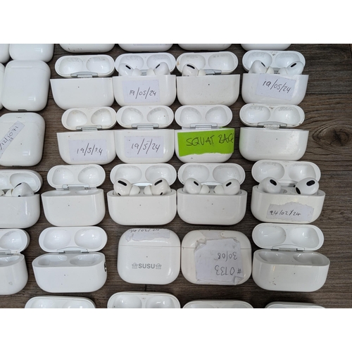 683 - A collection of Apple AirPod and AirPod style charging cases some with contents