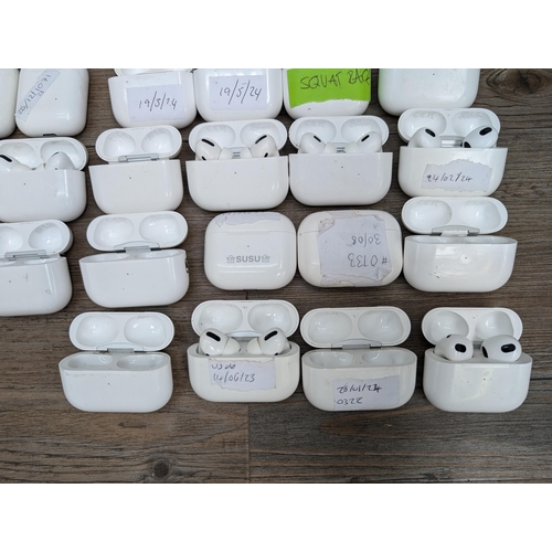 683 - A collection of Apple AirPod and AirPod style charging cases some with contents